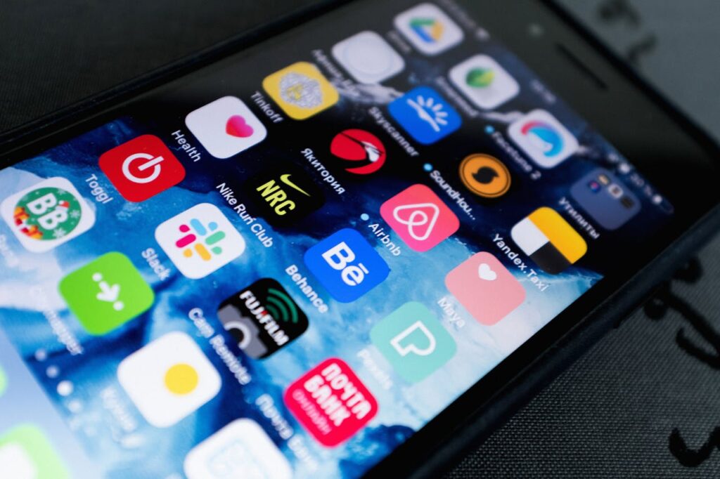 Detailed view of smartphone displaying multiple app icons on screen, highlighting technology use.